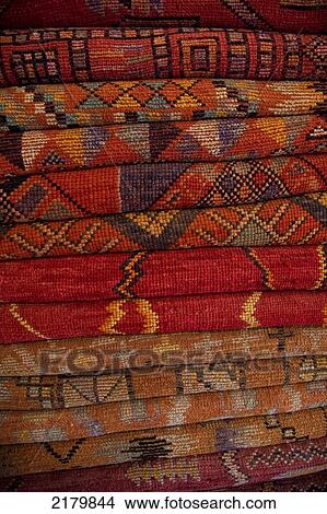 Picture - Pile of multi-coloured carpets in the souk; Marrakesh, Morocco. Fotosearch