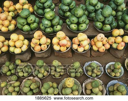 Stock Photography - Piles Of Mangoes And Lemons For Sale In A Market. Fotosearch
