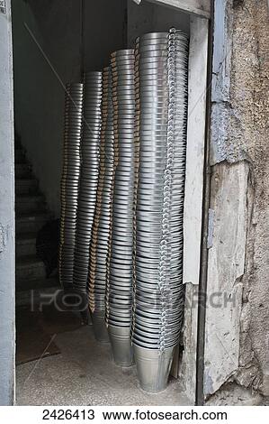 Stock Image - Piles of metal pails inside a doorway; Istanbul, Turkey. Fotosearch