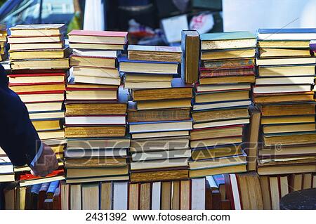Stock Image - Piles of used books for sale, Portobello Market; London, England. Fotosearch