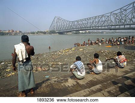 Stock Photograph - Pilgrims Beneath Howrah Bridge. Fotosearch