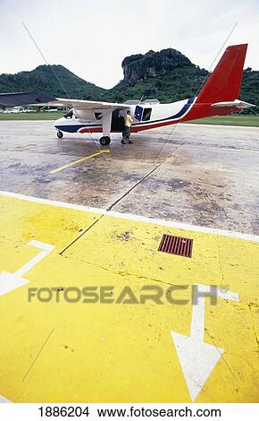Pilot And Small Plane At The Airport On The Runway View Large Photo Image Picture - Pilot And Small Plane At The Airport On The Runway. Fotosearch