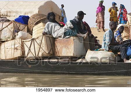 Stock Photo - Pinasse carrying cargo and passengers on the Niger River between Mopti and Lake Debo, Mali. Fotosearch