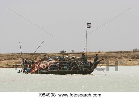 Stock Photo - Pinasse carrying cargo and passengers on the Niger River between Mopti and Lake Debo, Mali. Fotosearch