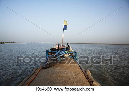 Stock Image - Pinasse on Lake Debo, formed by the seasonal flooding of the Niger River, Mali. Fotosearch