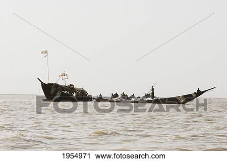 Stock Image - Pinasse on Lake Debo, formed by the seasonal flooding of the Niger River, Mali. Fotosearch