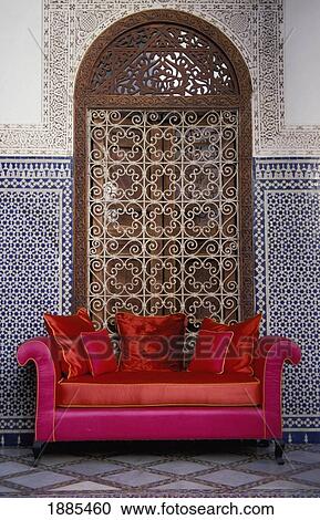 Stock Image - Pink And Red Sofa Before Arched Alcove And Window. Fotosearch