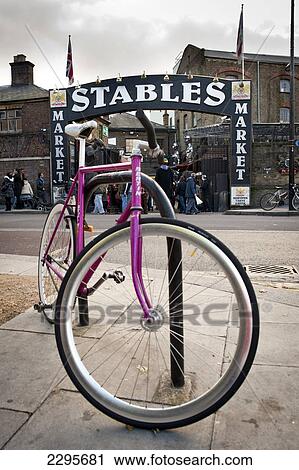 Stock Image - Pink Bicycle Parked In Front Og The Stables In Camden Market, North London, London, Uk. Fotosearch