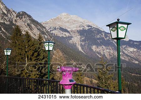 Stock Photography - Pink binoculars at a lookout with a view of the mountains; Kanzelkehre, Tyrol, Austria. Fotosearch