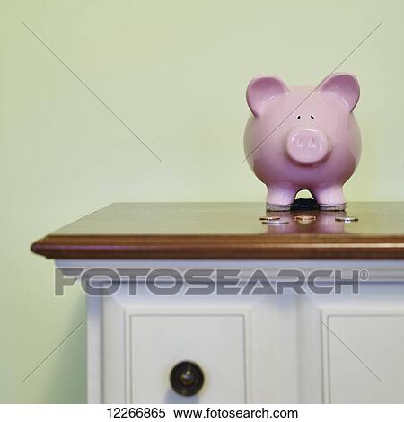 Pink piggy bank and a few coins on top of dresser; Ontario, Canada View Large Photo Image Stock Photography - Pink piggy bank and a few coins on top of dresser; Ontario, Canada. Fotosearch