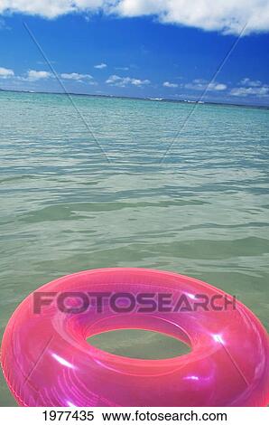 Stock Photography - Pink Swim Ring Floating In The Ocean Water.. Fotosearch