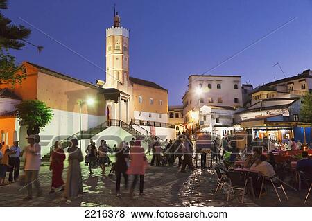 Stock Photo - Place Outa El Hammam With The Great Mosque On The Left At Dusk; Chefchaouen Province Morocco. Fotosearch