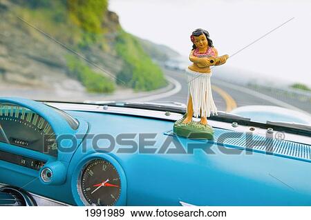 Stock Photo - Plastic Hula Doll On The Dashboard Of A Turquoise Thunderbird.. Fotosearch