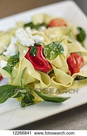 Plate of freshly made pasta with roasted red peppers, basil, and goat cheese; Ontario, Canada View Large Photo Image Stock Image - Plate of freshly made pasta with roasted red peppers, basil, and goat cheese; Ontario, Canada. Fotosearch
