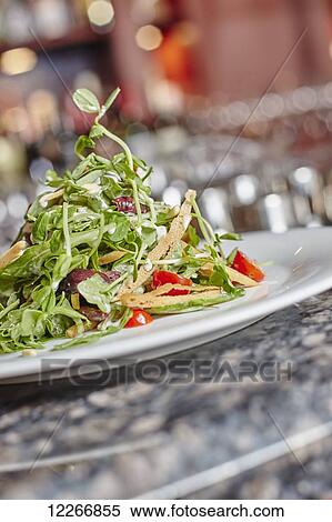 Plated salad with pancetta, cherry tomato, bread crisps, pine nuts, and dressing; Ontario, Canada View Large Photo Image Stock Photography - Plated salad with pancetta, cherry tomato, bread crisps, pine nuts, and dressing; Ontario, Canada. Fotosearch