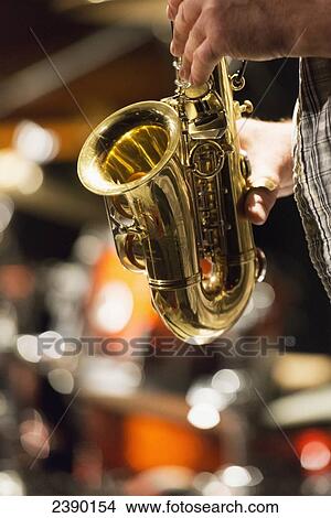 Picture - Playing a saxophone; Winnipeg, Manitoba, Canada. Fotosearch