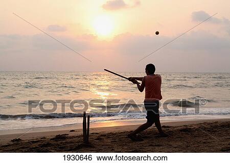 Playing cricket, the national sport of India, on Anjuna Beach at sunset, Goa State, India, Asia. View Large Photo Image Stock Photograph - Playing cricket, the national sport of India, on Anjuna Beach at sunset, Goa State, India, Asia.. Fotosearch