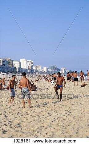 Stock Image - Playing Football On Ipanema Beach. Fotosearch