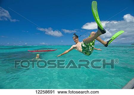 Playing in the turquoise water off a tropical island; Upulu Island, Samoa View Large Photo Image Stock Image - Playing in the turquoise water off a tropical island; Upulu Island, Samoa. Fotosearch