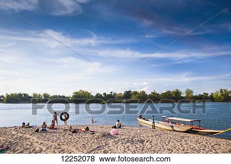Stock Photo - Playing on the beach on the island of Don Det on the Mekong River along the Cambodia/Laos border; Si Phan Don, Laos. Fotosearch