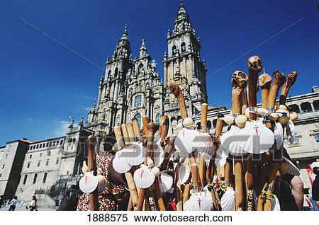 Stock Photography - Plaza Obradoiro With Western Facade Of Santiago Cathedral. Stall Selling Symbols Of Camino Scallop Shells And Staffs. Fotosearch