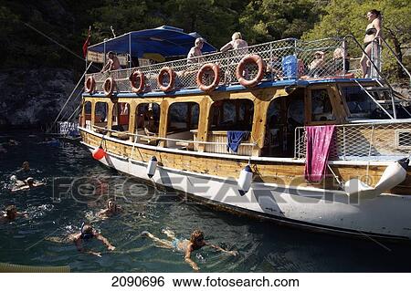 Pleasure Cruise Boats From Oludeniz And Swimmers In Coldwater Bay, The Turquoise Coast, Southern Turkey View Large Photo Image Stock Photograph - Pleasure Cruise Boats From Oludeniz And Swimmers In Coldwater Bay, The Turquoise Coast, Southern Turkey. Fotosearch