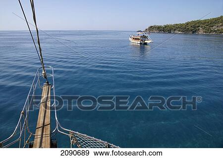 Pleasure Cruise Boats Leaving Harbor In Oludeniz, The Turquoise Coast, Southern Turkey View Large Photo Image Stock Photo - Pleasure Cruise Boats Leaving Harbor In Oludeniz, The Turquoise Coast, Southern Turkey. Fotosearch