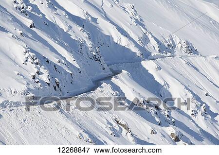Plowed, narrow mountain road on Mount Hutt on a sunny day, New Zealand View Large Photo Image Stock Photo - Plowed, narrow mountain road on Mount Hutt on a sunny day, New Zealand. Fotosearch