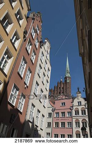Stock Photo - Poland, Townhouses On Main Town With Tower Of St Mary's Church (Bazylika Mariacka) In Background; Gdansk. Fotosearch