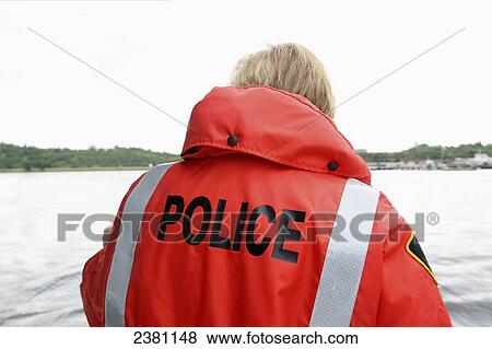 Police in orange jacket viewing water; Dryden, Ontario, Canada View Large Photo Image Stock Photo - Police in orange jacket viewing water; Dryden, Ontario, Canada. Fotosearch