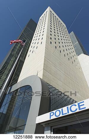 Stock Photo - Police sign and building with American flag; New York City, New York, United States of America. Fotosearch