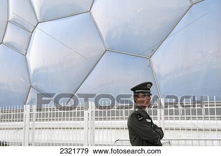 Policeman on duty outside 2008 Olympic Summer Village and Bird's Nest Stadium; Beijing, China View Large Photo Image Stock Photo - Policeman on duty outside 2008 Olympic Summer Village and Bird's Nest Stadium; Beijing, China. Fotosearch