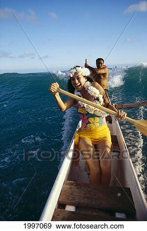Polynesian Beauty Paddles Outrigger Canoe, Front View Of Smiling Woman Local Man In Background, Steering A38G View Large Photo Image Stock Photo - Polynesian Beauty Paddles Outrigger Canoe, Front View Of Smiling Woman Local Man In Background, Steering A38G. Fotosearch