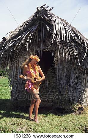 Polynesian Girl Playing Ukulele Near Grass Hut. View Large Photo Image Stock Photo - Polynesian Girl Playing Ukulele Near Grass Hut.. Fotosearch