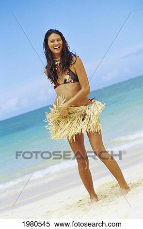 Stock Photography - Polynesian Woman Standing On White Sand Beach Near Ocean Shoreline.. Fotosearch