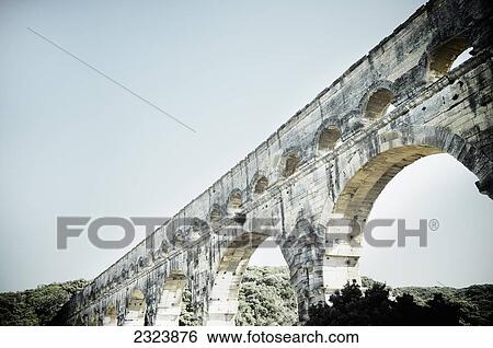 Stock Photograph - Pont du Gard, an ancient Roman aqueduct bridge; Vers-Pont-du-Gard, France. Fotosearch