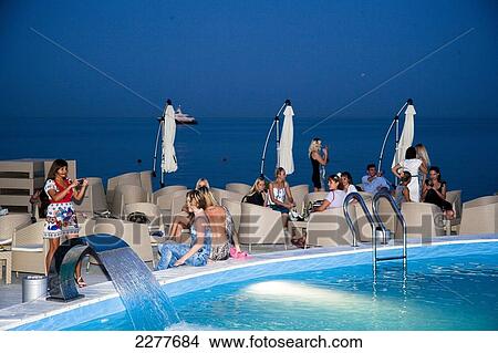Poolside at a high class night club on the beach; Odessa, Ukraine View Large Photo Image Picture - Poolside at a high class night club on the beach; Odessa, Ukraine. Fotosearch