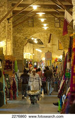 Stock Image - Porter with wheelbarrow in the Wafi Souk; Doha, Qatar. Fotosearch