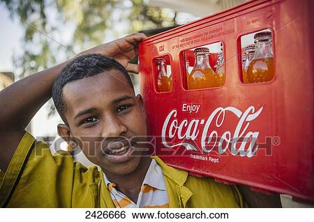 Portrait of a boy with coke crate in the city of Harar in Eastern Ethiopia; Harar, Ethiopia View Large Photo Image Stock Photograph - Portrait of a boy with coke crate in the city of Harar in Eastern Ethiopia; Harar, Ethiopia. Fotosearch
