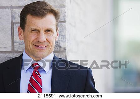 Stock Image - Portrait Of A Businessman Outdoors; Bradford Ontario Canada. Fotosearch
