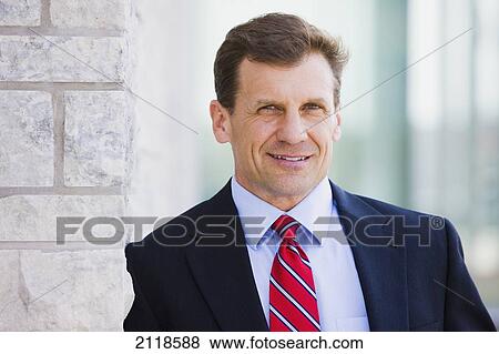 Portrait Of A Businessman Outdoors; Bradford Ontario Canada View Large Photo Image Stock Photo - Portrait Of A Businessman Outdoors; Bradford Ontario Canada. Fotosearch