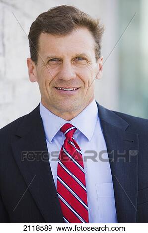 Stock Photo - Portrait Of A Businessman Outdoors; Bradford Ontario Canada. Fotosearch