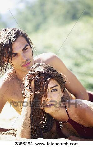 Portrait of a couple in a sexy pose on the beach; Hawaii, United States of America View Large Photo Image Picture - Portrait of a couple in a sexy pose on the beach; Hawaii, United States of America. Fotosearch