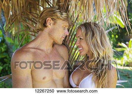 Portrait of a couple in swimwear on the beach; Kauai, Hawaii, United States of America View Large Photo Image Stock Image - Portrait of a couple in swimwear on the beach; Kauai, Hawaii, United States of America. Fotosearch