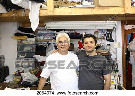 Picture - Portrait Of A Father And Son In The Family Business Alteration Shop, Hamilton, Ontario. Fotosearch