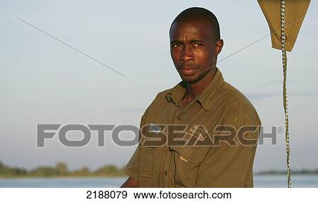 Stock Photo - Portrait of a man on a boat trip on the Zambezi River; Caprivi Strip, Namibia. Fotosearch