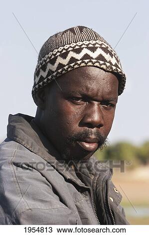 Stock Image - Portrait of a man on the Bani River, Mali. Fotosearch