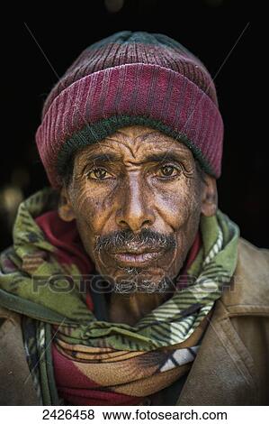 Stock Photo - Portrait of a man running a flour mill; Ethiopia. Fotosearch