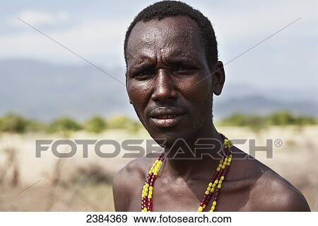 Stock Photo - Portrait of a man wearing a colourful beaded necklace; Omo Valley, Ethiopia. Fotosearch
