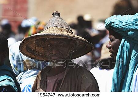 Stock Photo - Portrait of a man wearing a Fulani Straw Hat at Monday Market in Djenne, Mali. Fotosearch